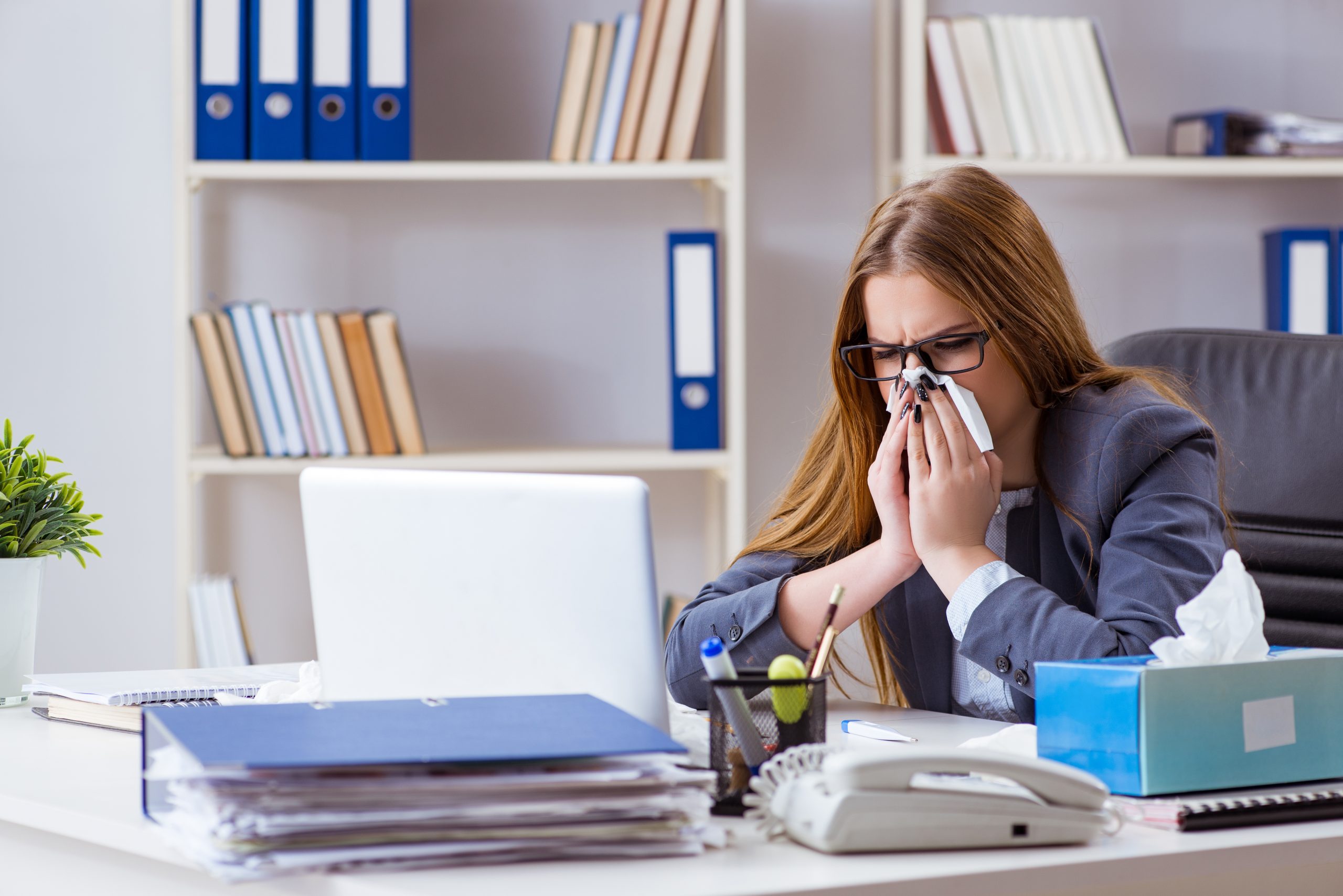 usinesswoman employee sick with flu in the office
